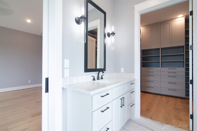 4410 Jozwiak Rd, Chappell Hill, TX 77426 - bathroom with vanity, wood finished floors, and a spacious closet
