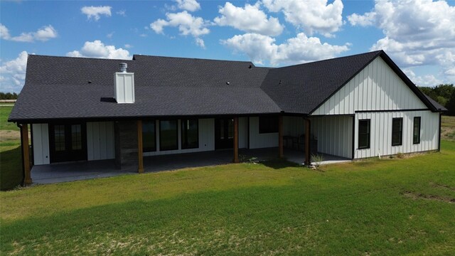 4410 Jozwiak Rd, Chappell Hill, TX 77426 - rear view of property with board and batten siding, a patio area, a lawn, and french doors