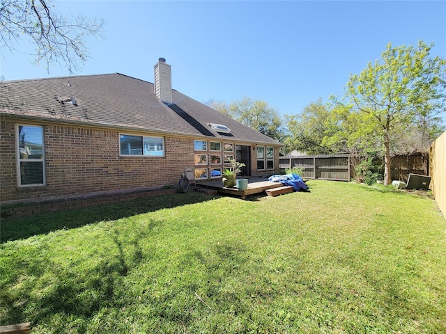 4021 Fatta Dr, Dickinson, TX 77539 - back of house with brick siding, a fenced backyard, a deck, and a chimney