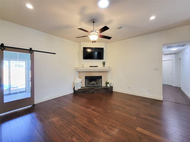4021 Fatta Dr, Dickinson, TX 77539 - unfurnished living room featuring hardwood / wood-style floors, ceiling fan, a stone fireplace, and recessed lighting