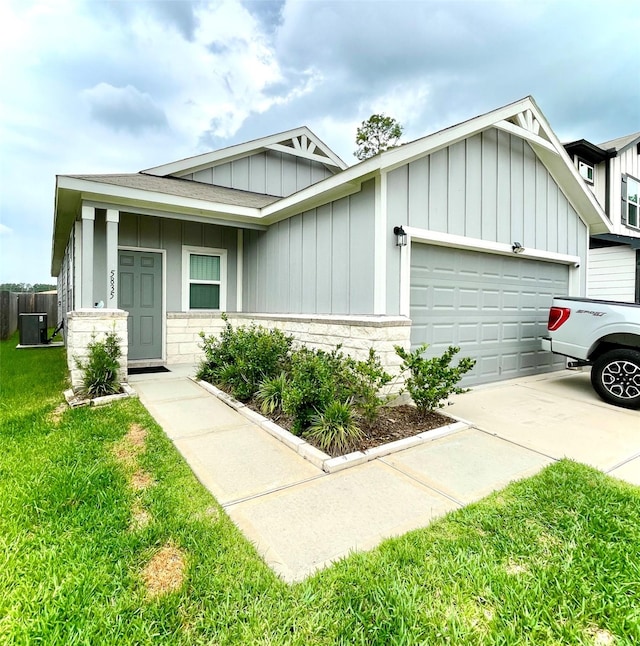 5835 Finely Run St, Spring, TX 77373 - view of front of house featuring board and batten siding, a garage, a front lawn, and driveway