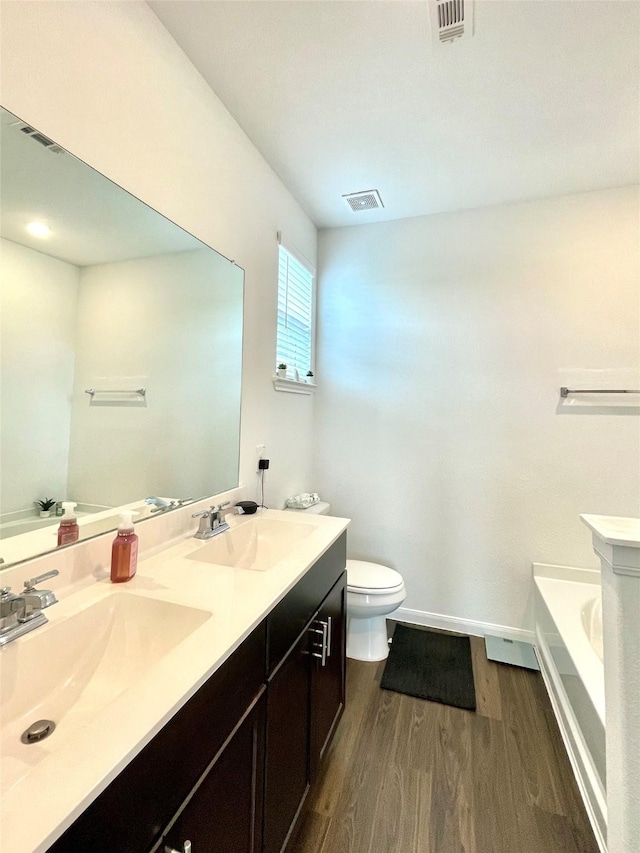 5835 Finely Run St, Spring, TX 77373 - bathroom featuring wood finished floors, a tub, and double vanity