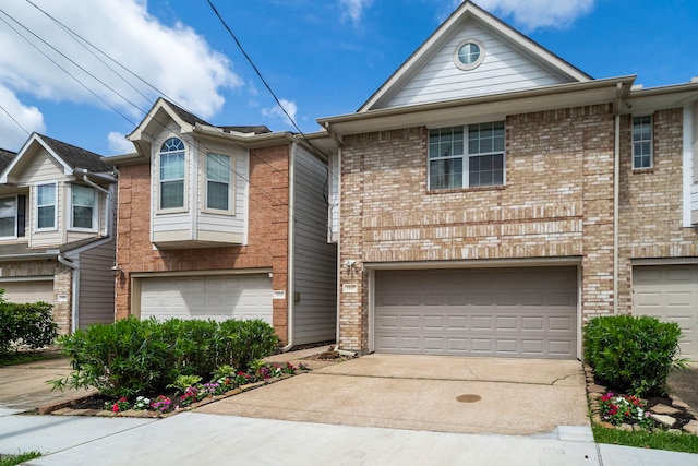 1517 Asbury St, Houston, TX 77007 - view of property featuring a garage, driveway, and brick siding