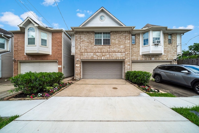 1517 Asbury St, Houston, TX 77007 - townhome / multi-family property featuring a garage, driveway, and brick siding