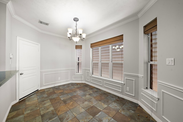 1517 Asbury St, Houston, TX 77007 - unfurnished dining area with a chandelier, dark stone finish floors, a decorative wall, ornamental molding, and wainscoting
