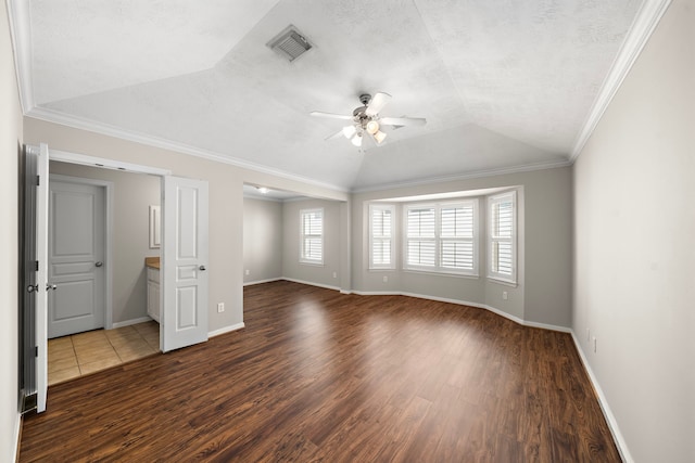 1517 Asbury St, Houston, TX 77007 - empty room featuring dark wood-type flooring, a ceiling fan, vaulted ceiling, and crown molding