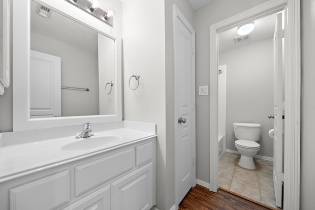 1517 Asbury St, Houston, TX 77007 - bathroom featuring vanity, wood finished floors, and bathing tub / shower combination