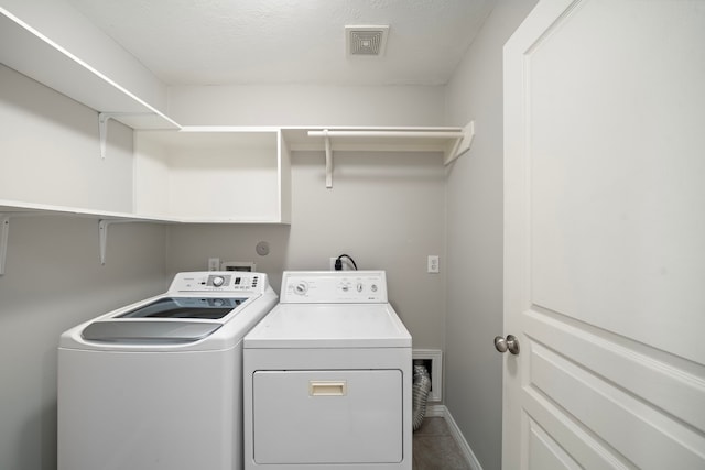 1517 Asbury St, Houston, TX 77007 - washroom with washing machine and dryer and tile patterned flooring
