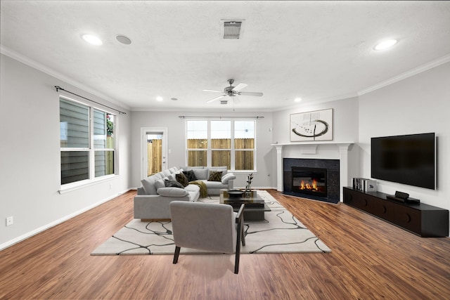 1517 Asbury St, Houston, TX 77007 - living area featuring crown molding, recessed lighting, wood finished floors, a tile fireplace, and a ceiling fan