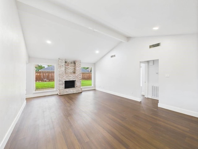 8918 Bold Forest Dr, Houston, TX 77088 - unfurnished living room with beam ceiling, dark wood finished floors, a brick fireplace, recessed lighting, and high vaulted ceiling