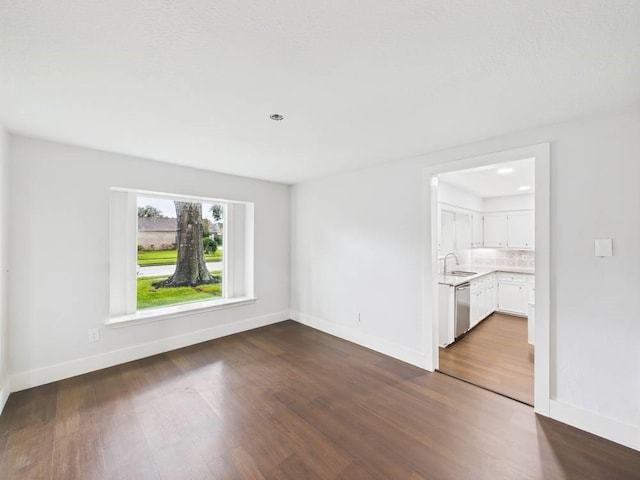 8918 Bold Forest Dr, Houston, TX 77088 - unfurnished room featuring dark wood-style floors and baseboards