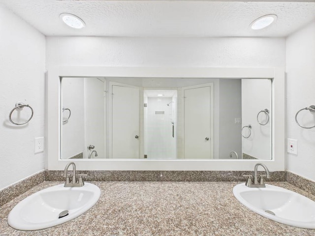 8918 Bold Forest Dr, Houston, TX 77088 - bathroom with vanity, a shower stall, and a textured ceiling
