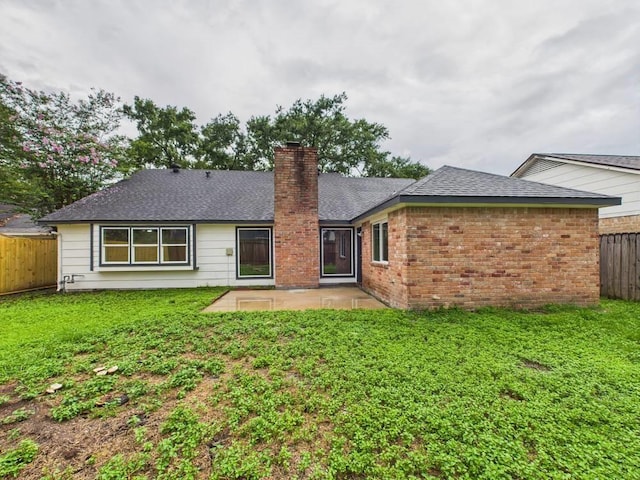 8918 Bold Forest Dr, Houston, TX 77088 - back of house featuring a chimney, a patio, a fenced backyard, brick siding, and roof with shingles