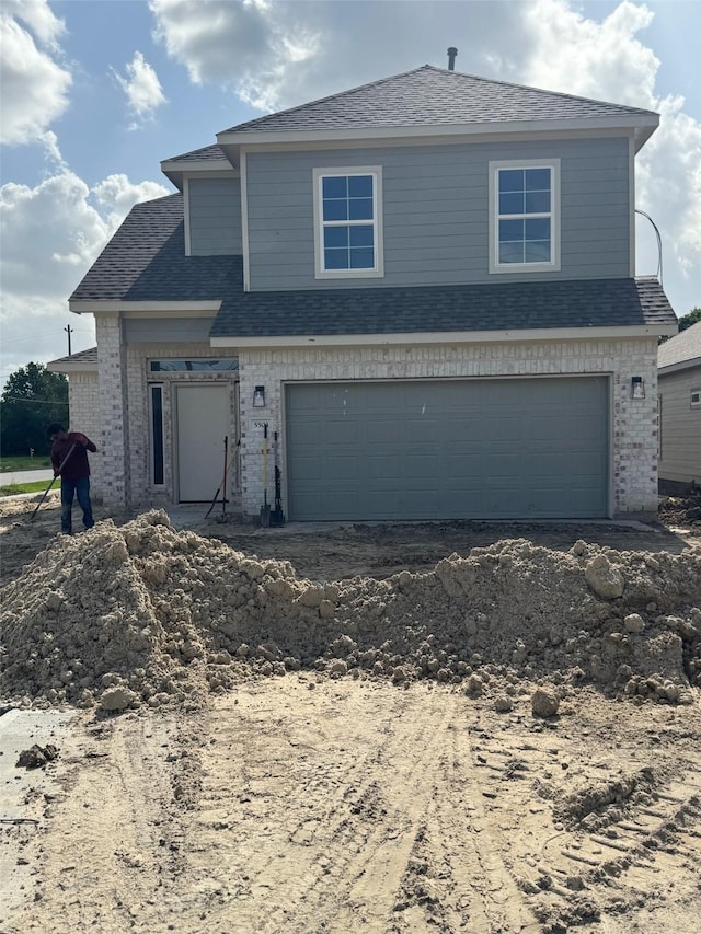 5503 Bacher St, Houston, TX 77028 - view of front facade featuring brick siding, a garage, driveway, and a shingled roof
