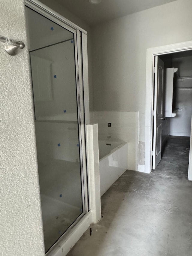 5503 Bacher St, Houston, TX 77028 - bathroom with a shower stall, concrete floors, a bath, and a textured wall