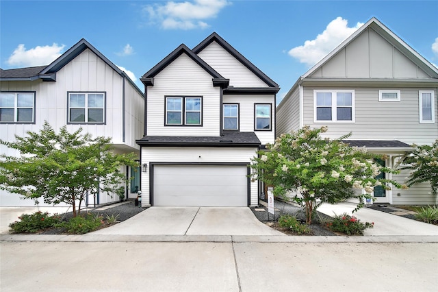 6727 Parker Oaks Ln, Houston, TX 77076 - view of front of house with board and batten siding, concrete driveway, and a garage