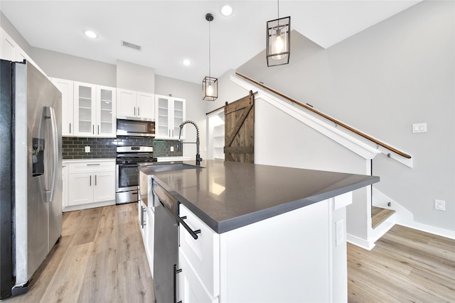 6727 Parker Oaks Ln, Houston, TX 77076 - kitchen featuring appliances with stainless steel finishes, dark countertops, light wood-style flooring, backsplash, and white cabinetry