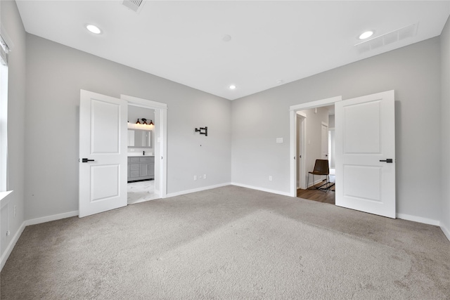 6727 Parker Oaks Ln, Houston, TX 77076 - unfurnished bedroom with carpet, ensuite bath, and recessed lighting