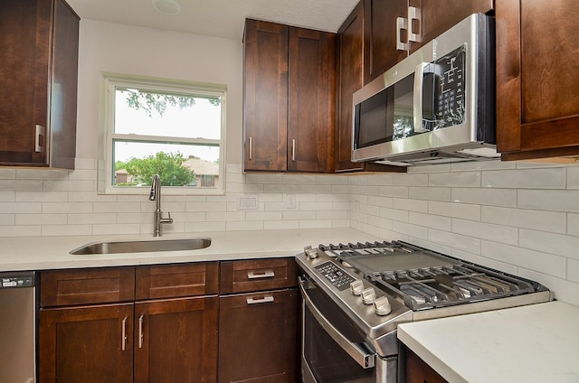 14835 Charlmont Dr, Houston, TX 77083 - kitchen with appliances with stainless steel finishes, light countertops, and decorative backsplash