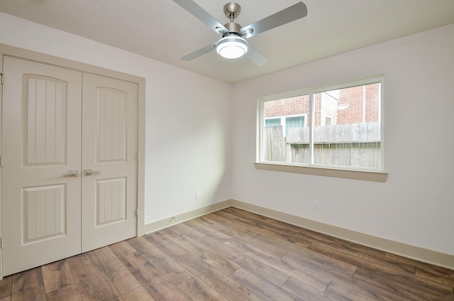 14835 Charlmont Dr, Houston, TX 77083 - unfurnished bedroom featuring wood finished floors, a closet, and a ceiling fan
