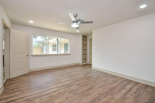 14835 Charlmont Dr, Houston, TX 77083 - empty room with wood finished floors, ceiling fan, recessed lighting, and a textured ceiling