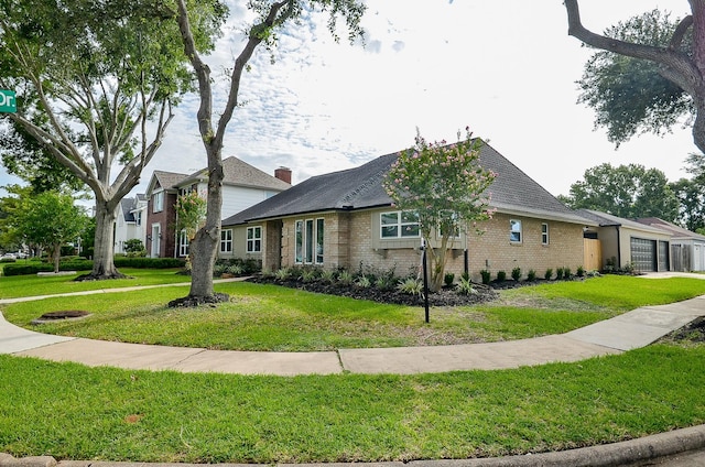 14835 Charlmont Dr, Houston, TX 77083 - view of front of property with an attached garage, brick siding, and a front lawn