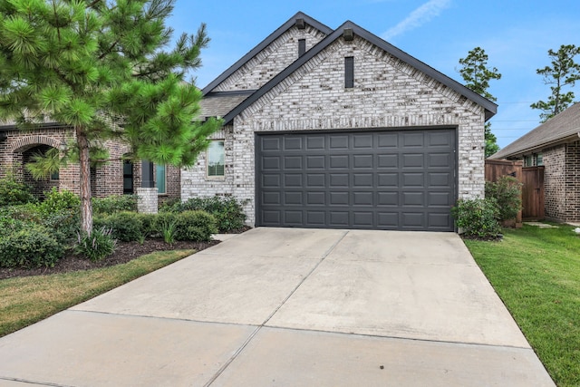 12350 Castano Creek Dr, Humble, TX 77346 - view of front of home featuring a garage, brick siding, and concrete driveway