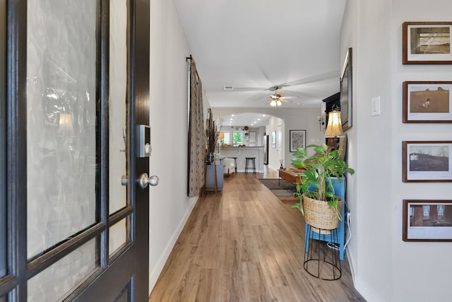 12350 Castano Creek Dr, Humble, TX 77346 - hall featuring arched walkways and light wood-type flooring