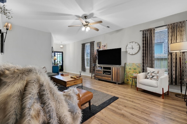 12350 Castano Creek Dr, Humble, TX 77346 - living area with plenty of natural light, light wood finished floors, and a ceiling fan