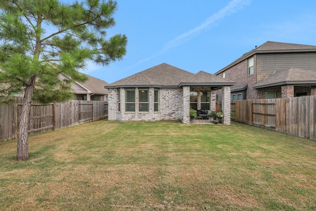 12350 Castano Creek Dr, Humble, TX 77346 - rear view of house featuring a fenced backyard, brick siding, roof with shingles, and a patio area