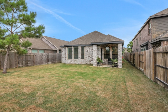 12350 Castano Creek Dr, Humble, TX 77346 - rear view of house featuring brick siding, a fenced backyard, and roof with shingles