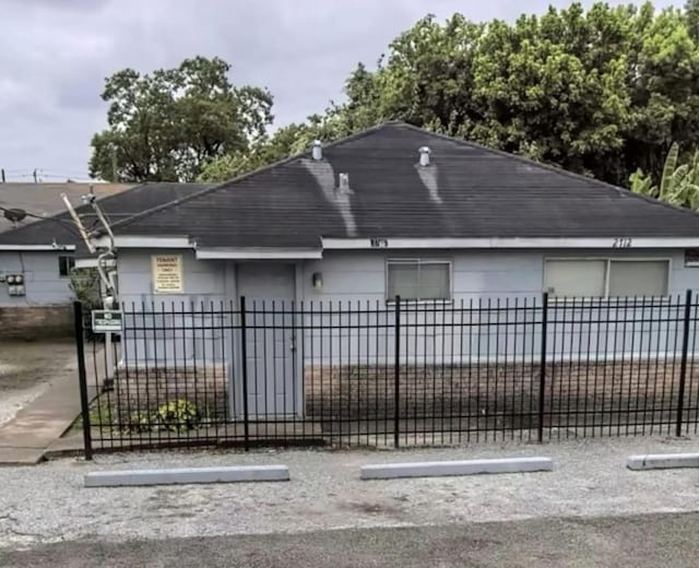 2712/2716 Berry St, Houston, TX 77004 - view of front of property with a fenced front yard and a shingled roof