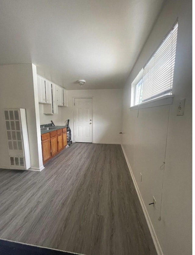 2712/2716 Berry St, Houston, TX 77004 - unfurnished living room featuring baseboards and dark wood-style floors