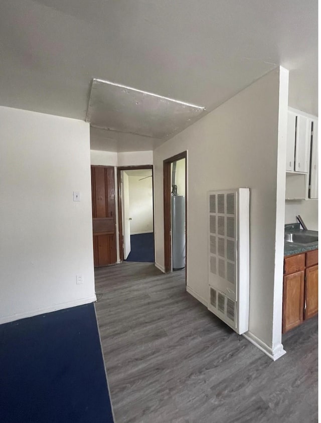 2712/2716 Berry St, Houston, TX 77004 - hallway featuring dark wood-style floors, gas water heater, a heating unit, and heating unit