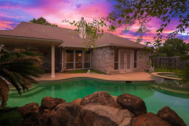 3106 Rainbow Ct, Pearland, TX 77584 - pool at dusk featuring french doors, an in-ground hot tub, a patio, and a ceiling fan