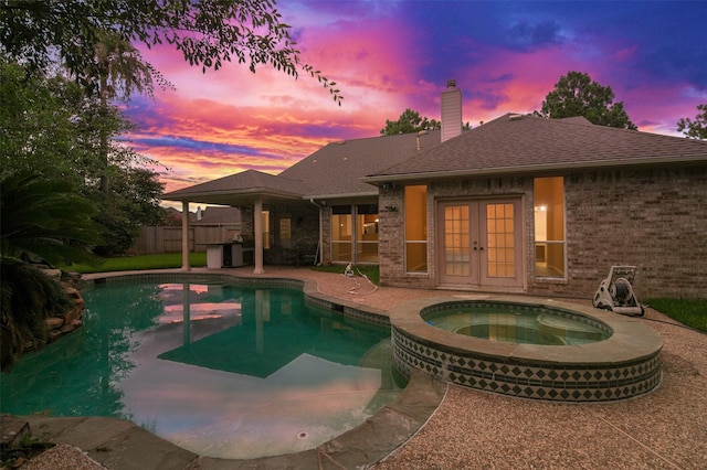 3106 Rainbow Ct, Pearland, TX 77584 - view of swimming pool with french doors, a patio area, and a pool with connected hot tub
