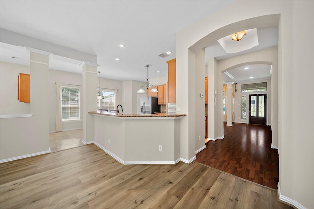 3106 Rainbow Ct, Pearland, TX 77584 - kitchen featuring stainless steel fridge with ice dispenser, wood finished floors, plenty of natural light, recessed lighting, and hanging light fixtures