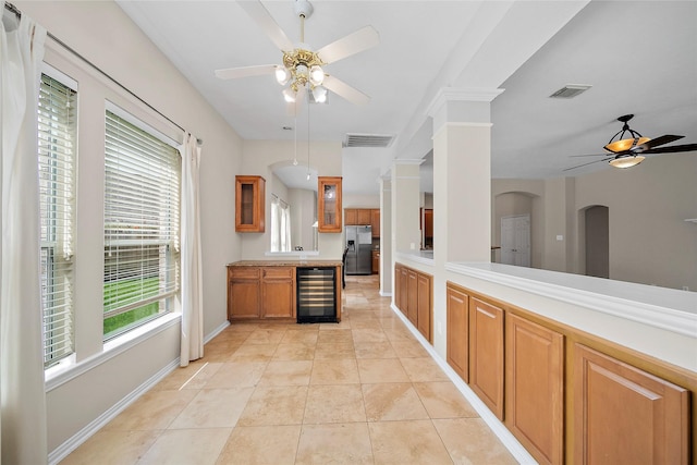 3106 Rainbow Ct, Pearland, TX 77584 - kitchen featuring a ceiling fan, stainless steel refrigerator with ice dispenser, beverage cooler, brown cabinets, and light countertops