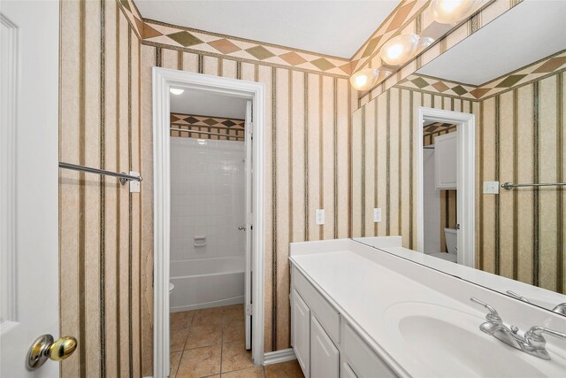 3106 Rainbow Ct, Pearland, TX 77584 - bathroom with vanity, tile patterned flooring, wallpapered walls, and washtub / shower combination