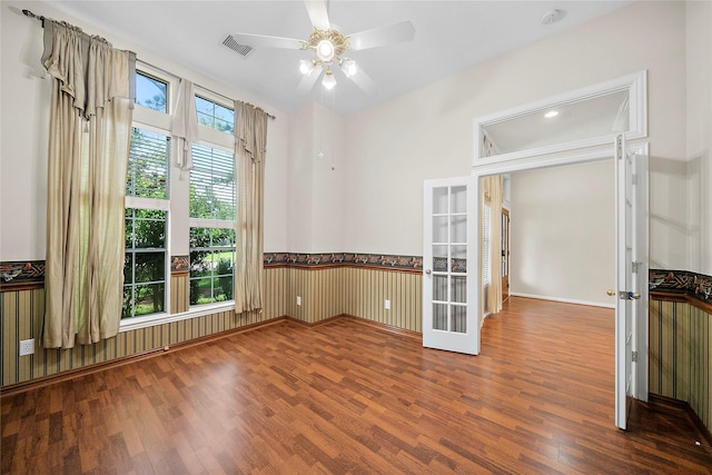 3106 Rainbow Ct, Pearland, TX 77584 - empty room with wood finished floors, french doors, a ceiling fan, a smoke detector, and wainscoting