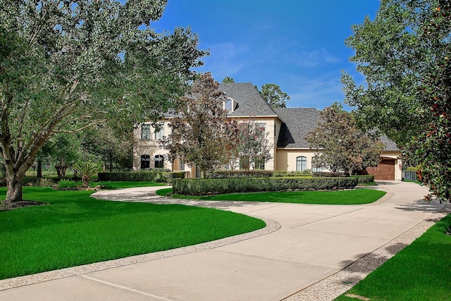 227 Starlight Pl, The Woodlands, TX 77380 - view of front of home with curved driveway and a front lawn