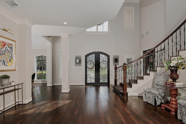 227 Starlight Pl, The Woodlands, TX 77380 - foyer entrance featuring decorative columns, french doors, stairs, hardwood / wood-style flooring, and crown molding