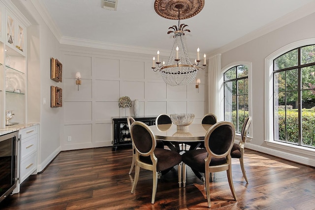 227 Starlight Pl, The Woodlands, TX 77380 - dining space featuring beverage cooler, ornamental molding, a chandelier, dark wood-style flooring, and bar