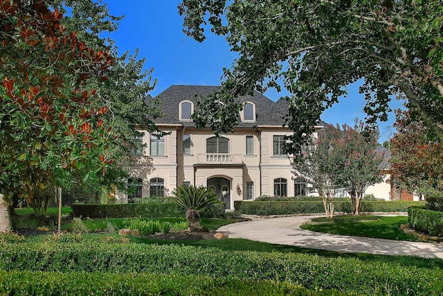 227 Starlight Pl, The Woodlands, TX 77380 - french provincial home with stucco siding and a front yard