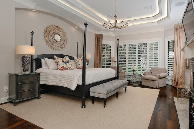 227 Starlight Pl, The Woodlands, TX 77380 - bedroom featuring a chandelier, dark wood finished floors, crown molding, a raised ceiling, and recessed lighting