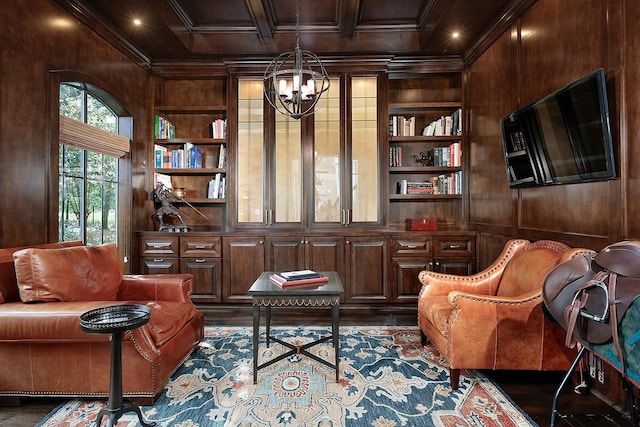 227 Starlight Pl, The Woodlands, TX 77380 - sitting room with wooden walls, built in features, a chandelier, dark wood-style flooring, and ornamental molding