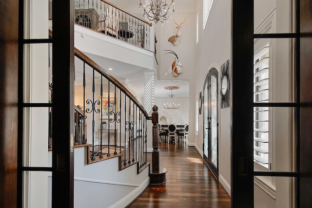 227 Starlight Pl, The Woodlands, TX 77380 - foyer entrance featuring a chandelier, hardwood / wood-style floors, french doors, stairway, and a high ceiling