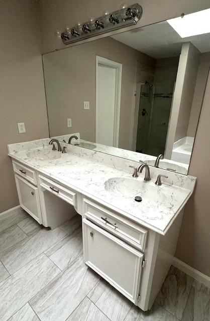 50 Evanston St Unit 5, Houston, TX 77015 - bathroom with a skylight, a stall shower, and double vanity