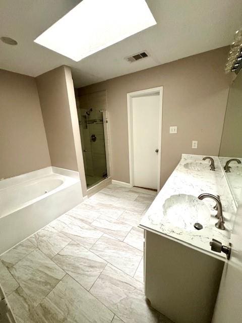 50 Evanston St Unit 5, Houston, TX 77015 - full bathroom with a stall shower, a bath, double vanity, and a skylight