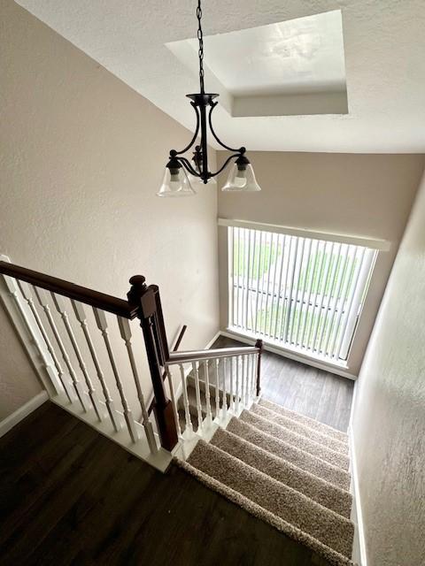 50 Evanston St Unit 5, Houston, TX 77015 - stairway with wood finished floors, a textured wall, and a tray ceiling